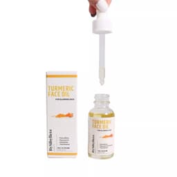 Flacon d'Huile Visage au Curcuma (Turmeric Face Oil) By Sibyllete (30g) avec sa pipette goutte-à-goutte tenue au-dessus du flacon et son étui.